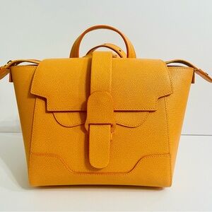 Senreve Orange Backpack with Geometric Flap Closure and Structured Design